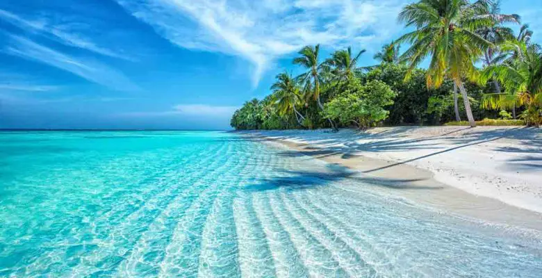 Seculded white-sand beach with clear water in the Maldives, tropical islands in South Asia