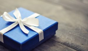 Blue elegant gift box on a wooden background