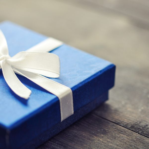 Blue elegant gift box on a wooden background