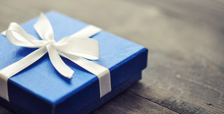 Blue elegant gift box on a wooden background