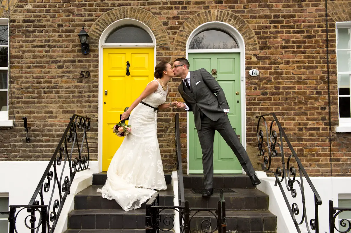 A happy bride and groom kiss on their wedding day in London