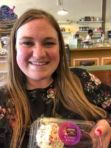 Woman holds cupcakes in to-go box from Good Cakes & Bakes in Detroit, Michigan, USA
