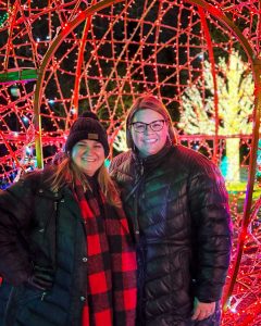 Two women pose for a festive photo at the Detroit Zoo's Wild Lights in Royal Oak, Michigan, USA