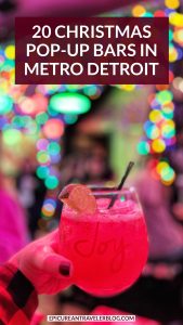 20 Christmas pop-up bars in Metro Detroit with a festive cocktail held at a bar decorated with twinkling colorful holiday lights