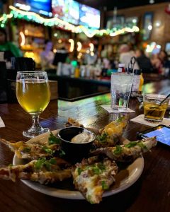 McShane's Irish Pub & Whiskey Bar potato skins and drinks at the bar in Detroit, Michigan, USA