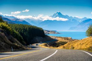 Scenic road trip of Mt Cook over a winding road near Lake Pukaki on a sunny day in New Zealand