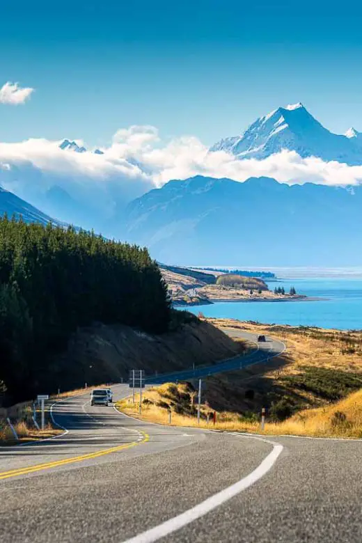 Scenic road trip of Mt Cook over a winding road near Lake Pukaki on a sunny day in New Zealand