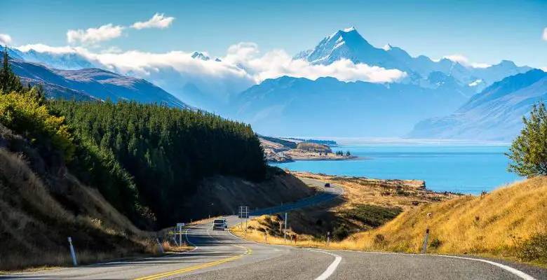 Scenic road trip of Mt Cook over a winding road near Lake Pukaki on a sunny day in New Zealand