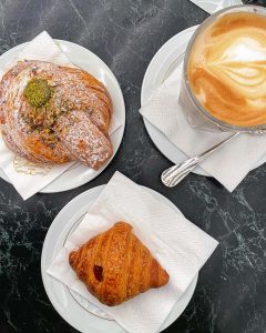 Pistachio cornetto, jam-filled cornetto, and latte at Marschesi 1824 inside the Galleria Vittorio Emanuele II