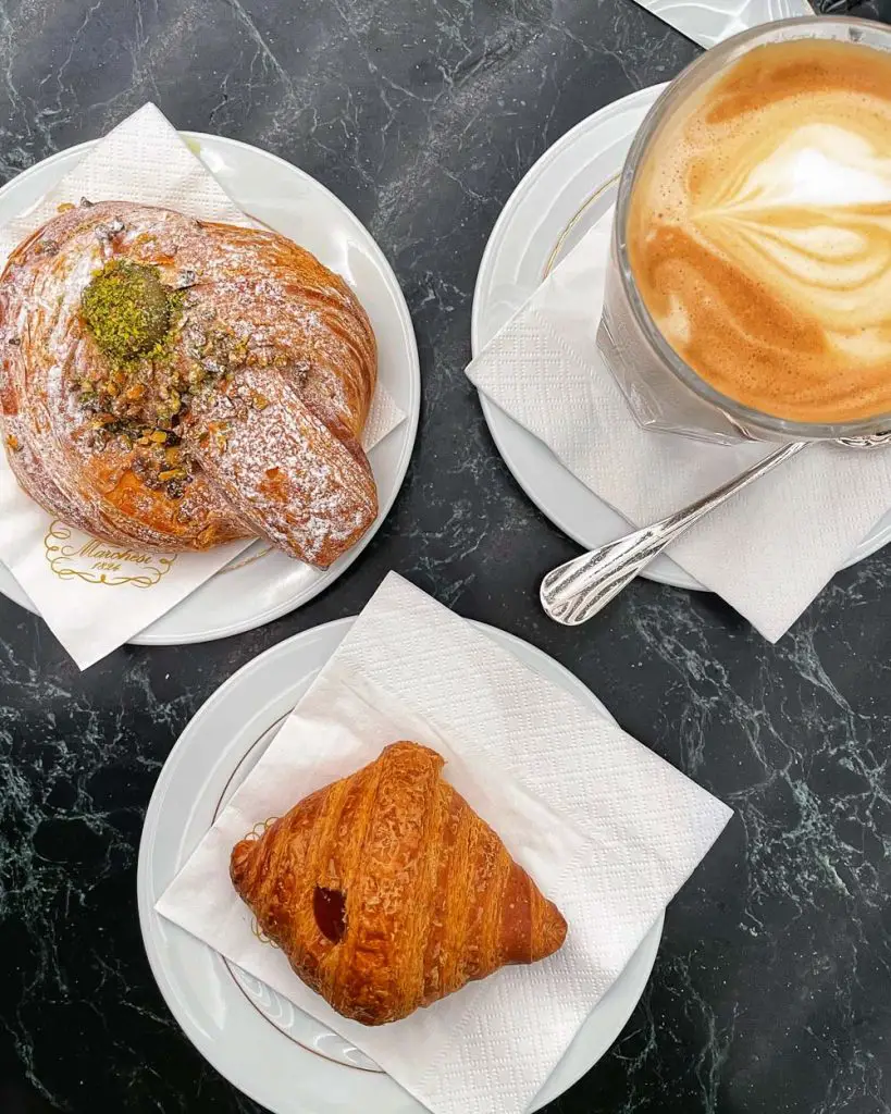 Pistachio cornetto, jam-filled cornetto, and latte at Marschesi 1824 inside the Galleria Vittorio Emanuele II