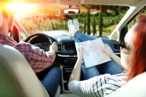 A couple drives into the countryside on a road trip