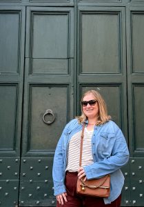 Female traveler wearing a chambray button-down shirt layered over a T-shirt in Rome