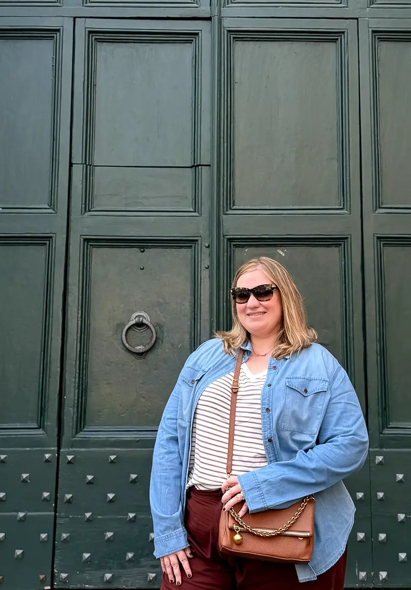 Female traveler wearing a chambray button-down shirt layered over a T-shirt in Rome
